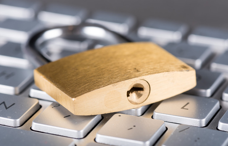 Padlock on computer keyboard, closeup